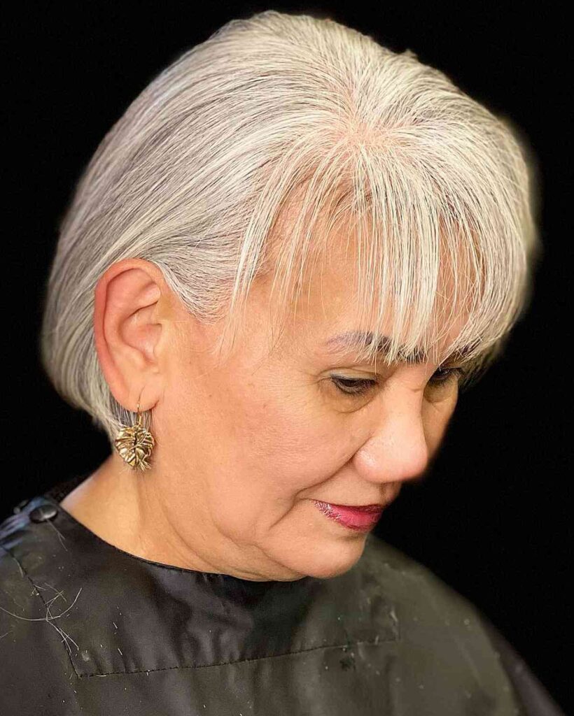 grey natural color with wispy bangs for a woman over sixty