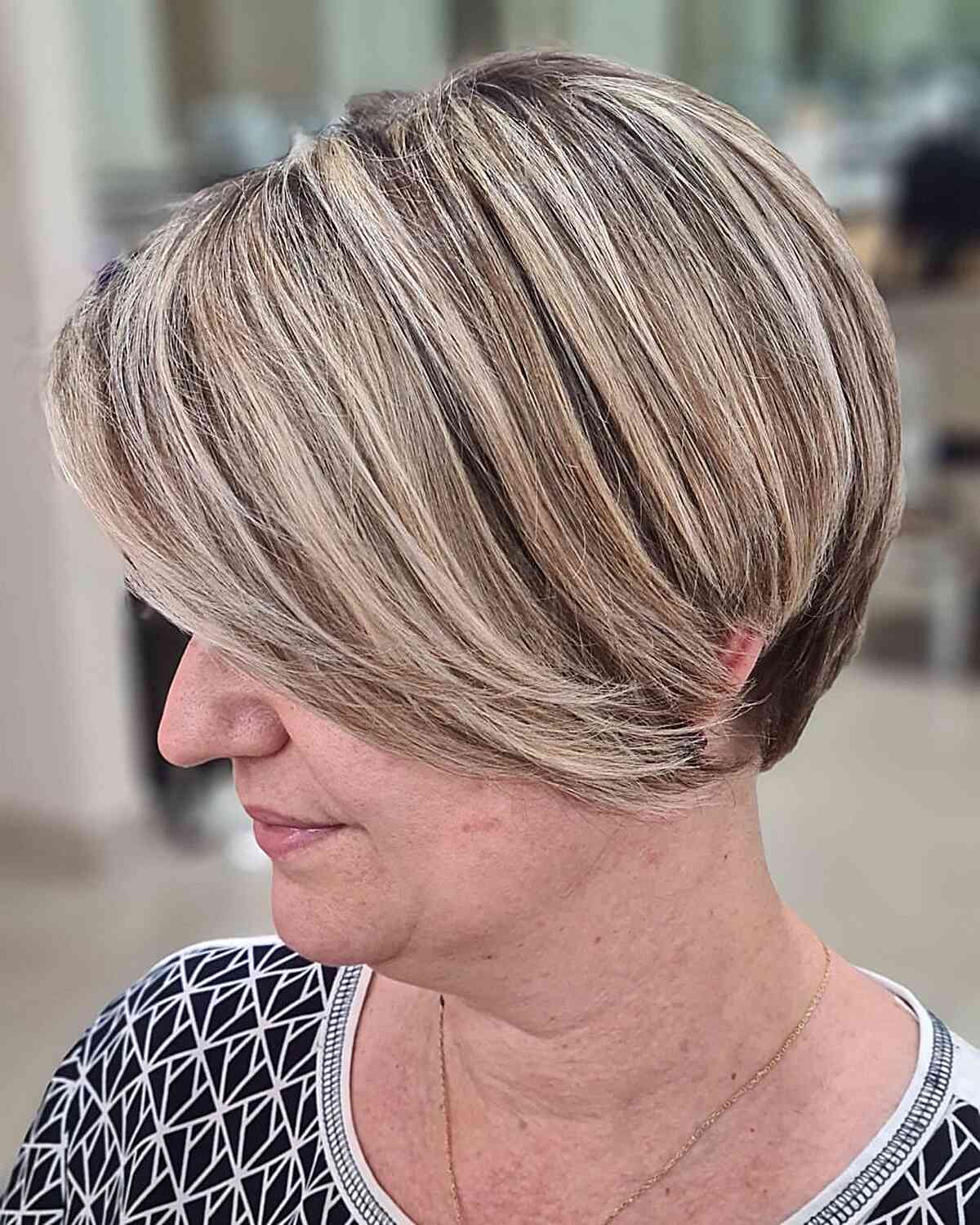 dimensional short pixie bob with blonde highlights for mature women