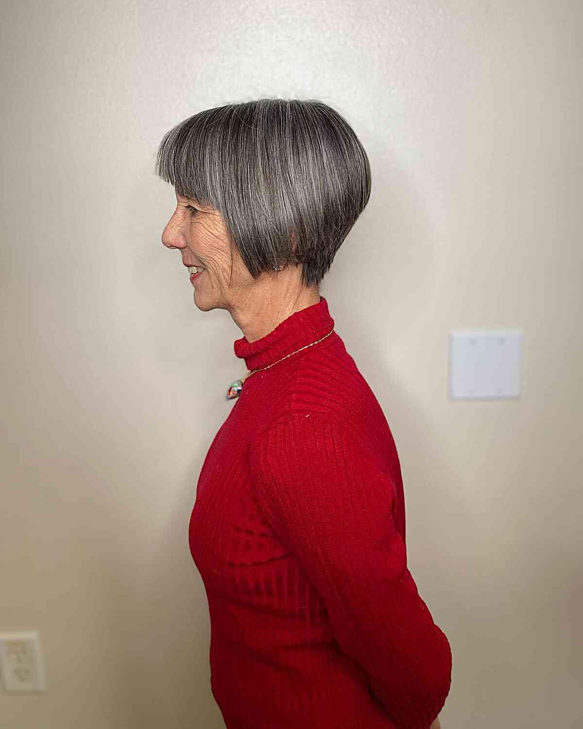 jaw grazing a line pixie bob with straight bangs on grey haired old women