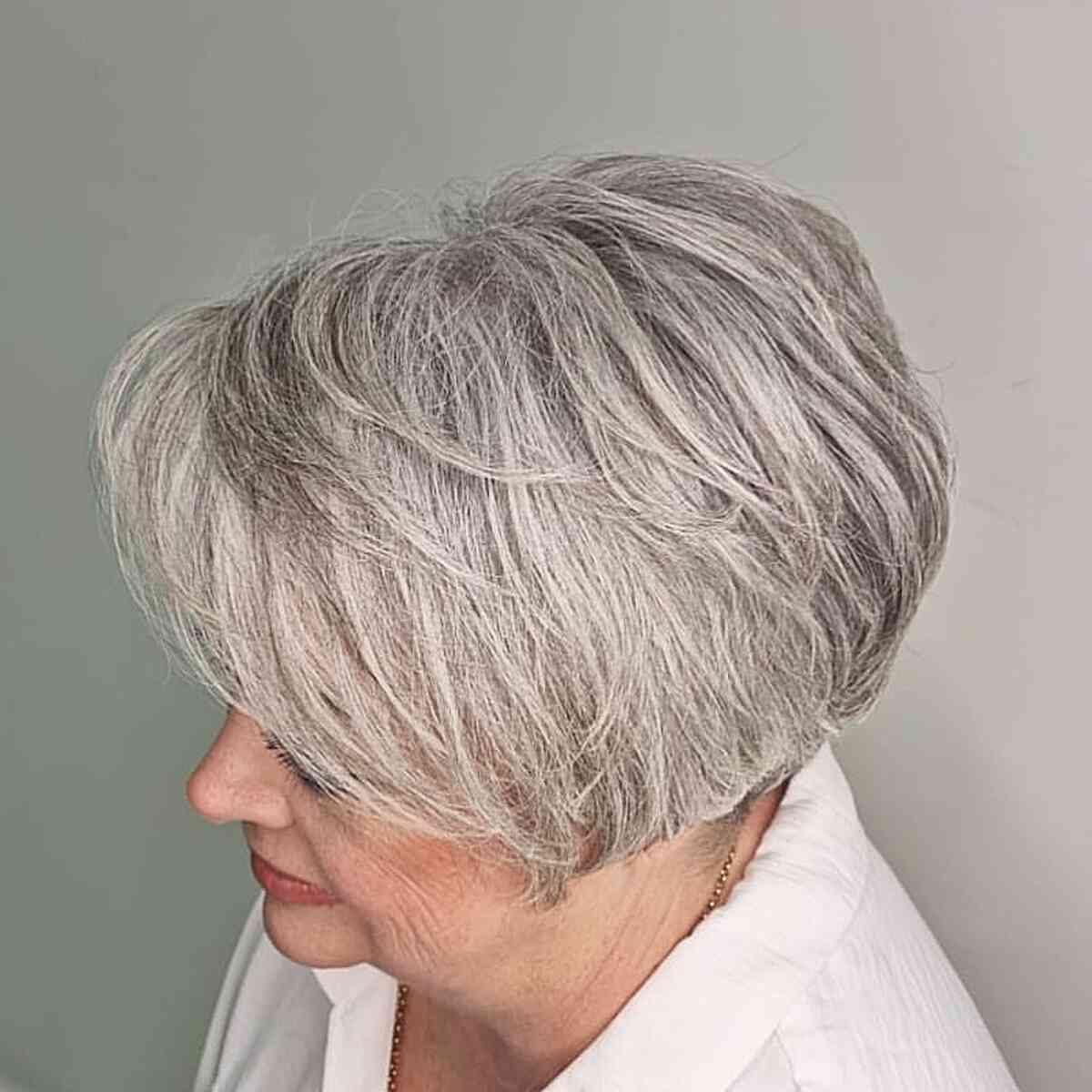 jaw length grey layered pixie bob with soft waves for older women